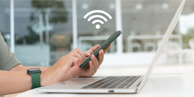 Woman using mobile phone at desk